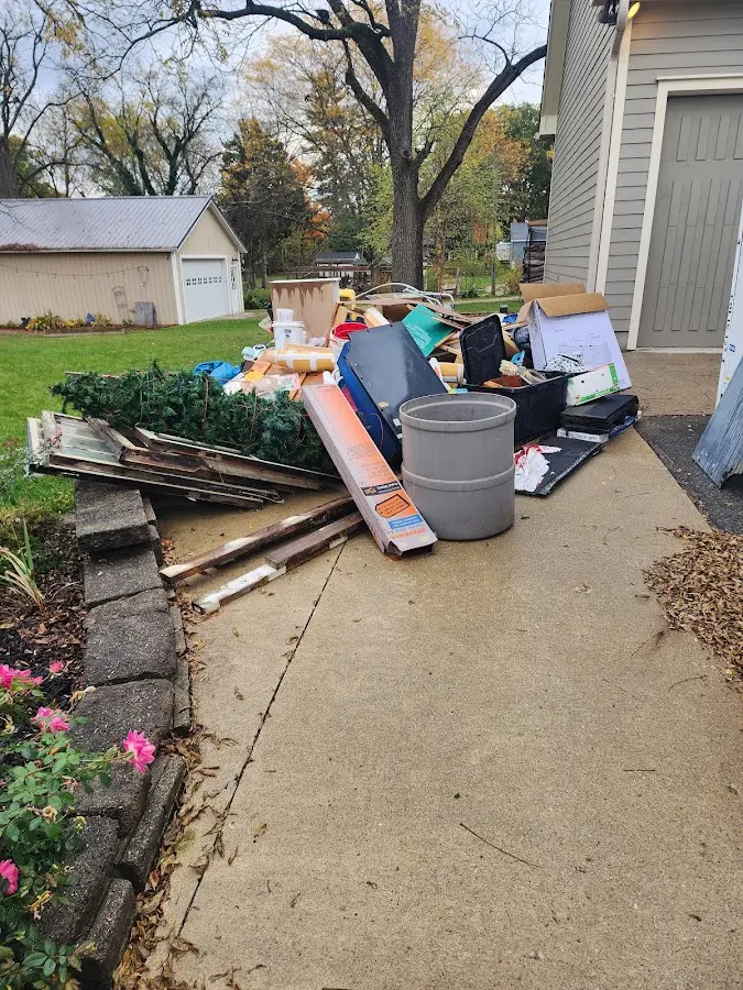 Dumpster being loaded with debris for Commercial Dumpster Rental in Green Brook